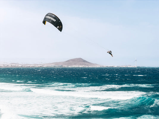 Green Hat Kiteboarding-Core XR Pro 2 Kite-Action Shot-Man Jumping in the Air While Kiteboarding on the XR2 Pro