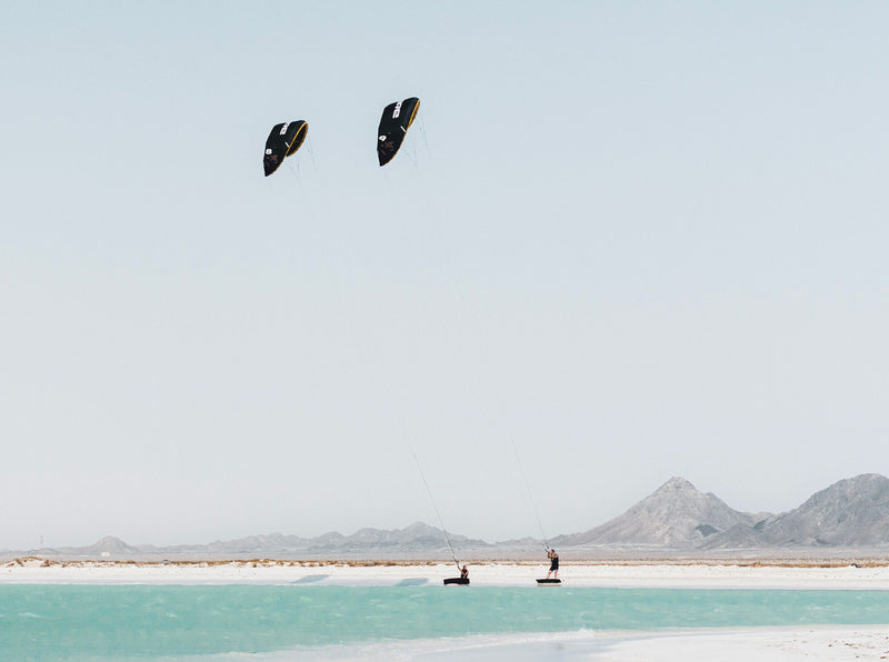 Load image into Gallery viewer, Green Hat Kiteboarding-Core XR Pro 2 Kite-Action Shot-Man and Woman on a Beach Flying the XR2 Pro
