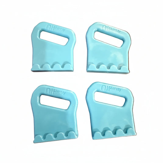Four light blue plastic strap buckles on a white surface