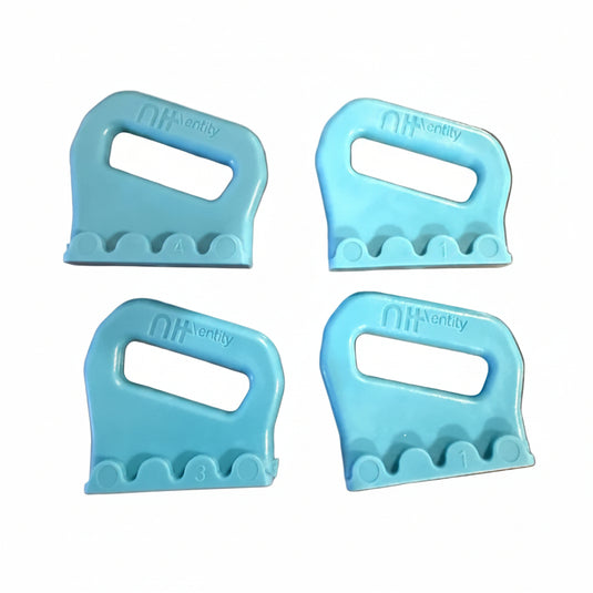 Four light blue plastic buckles on a white surface