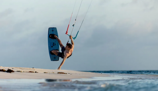 Green Hat Kiteboarding-Jaime SLS Kiteboard-Action Shot-Man Jumping in the Air While Kiteboarding on Jaime Board