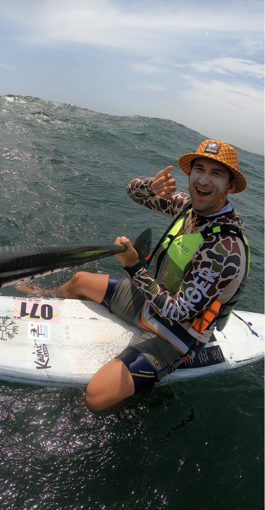 Green Hat Kiteboarding-Ed-Team Rider Sitting on his Downwind SUP Board in the Ocean