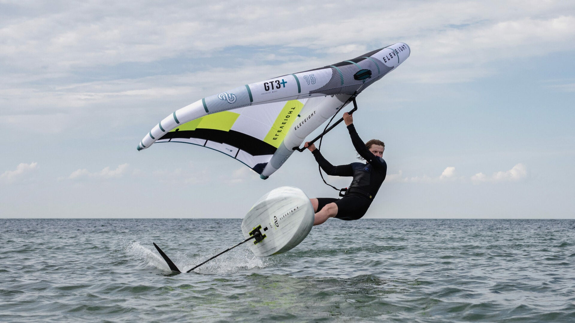 Green Hat Kiteboarding-Pages-All Packages-Action Shot-Man Wing Foiling on Eleveight Gear