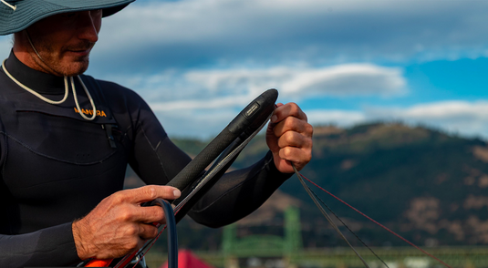 Green Hat Kiteboarding-F-One ATOM Control Bar-Live Shot-Man Rolling the Lines on his ATOM Bar