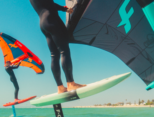 Green Hat Kiteboarding-F-One Origin V1 Wing-Action Shot-Close Up of 2 Men Winging on F-One Origin V1