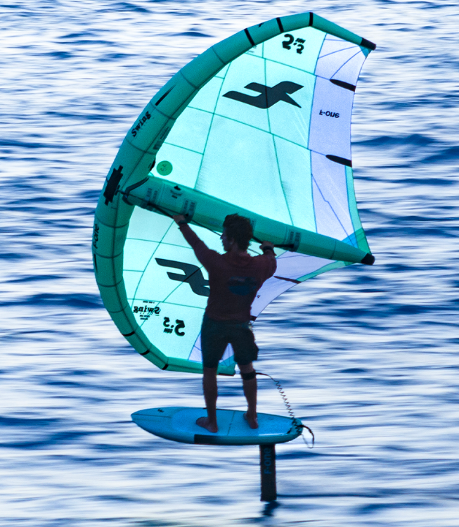 Load image into Gallery viewer, Green Hat Kiteboarding-F-One Swing V4-Action Shot-Man Wing Foiling on the  F-One Swing Wing
