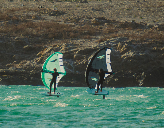 Green Hat Kiteboarding-F-One Swing V4-Action Shot-2 Men Wing Foiling on the 2 Different Swing Colors