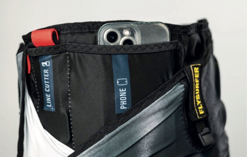 Load image into Gallery viewer, Close-up of a Flysurfer Escape Harness with a phone pocket and Flysurfer branding.
