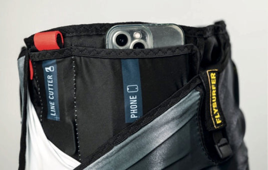 Close-up of a Flysurfer Escape Harness with a phone pocket and Flysurfer branding.
