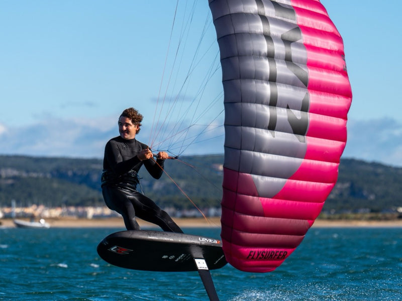 Load image into Gallery viewer, Person parawinging with a Flysurfer ZAP Parawing on a body of water.
