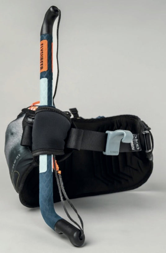 Flysurfer Escape Harness packed with orange and blue handle and parawing on a gray background