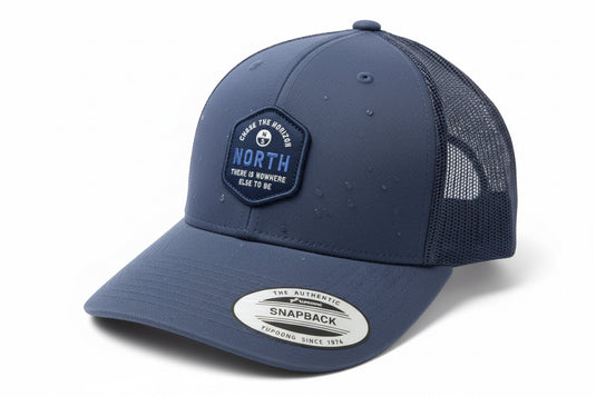 Blue cap with branding on a white surface
