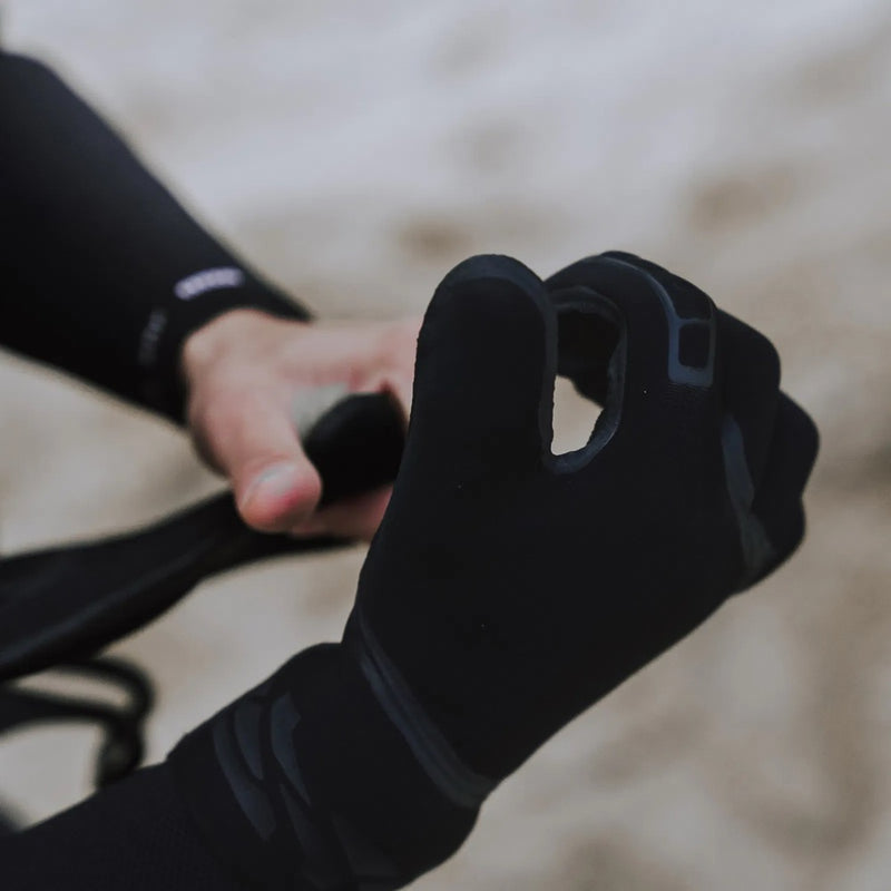 Load image into Gallery viewer, Person wearing black Ion pre-curved gloves holding a black object against a blurred background
