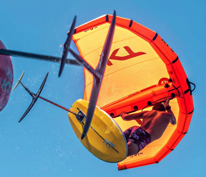 Load image into Gallery viewer, Green Hat Kiteboarding-KT Foils Nomad FW-Action Shot-Man Wing Foiling in the Air Riding a Nomad Foil
