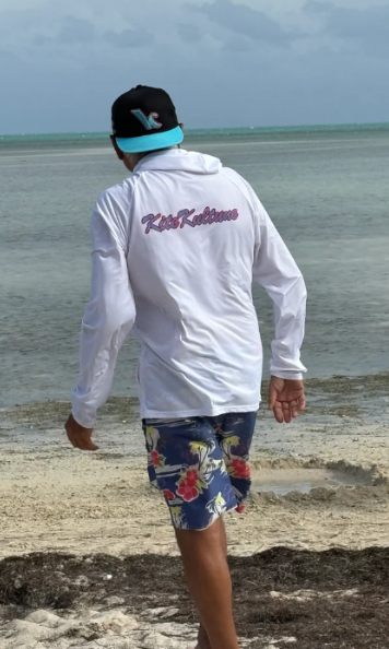 Load image into Gallery viewer, Green Hat Kiteboarding-Kite Kulture White long-sleeve jacket-Live Shot-Man on a beach Wearing the Jacket
