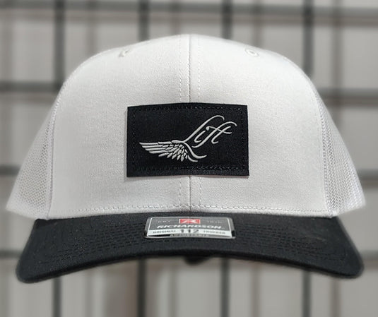 Green Hat Kiteboarding-Lift Foils Original Trucker Hat-White-Front View of  cap  on a grid background