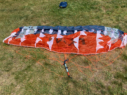 Rear bottom-side view of para wing, control bar, and lines.