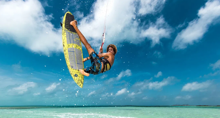 Green Hat Kiteboarding-Pages-Man Kitesurfing on a Directional Board in the air