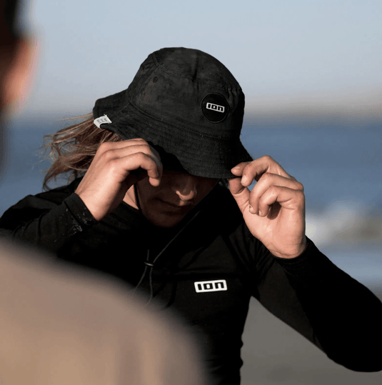 Green Hat Kiteboarding-Products-Ion Bucket hat worn by Kiter on the Beach