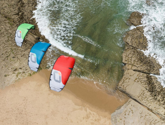 Load image into Gallery viewer, Green Hat Kiteboarding-Ozone REO V7  Kite-Live Shot-Drone View of All 3 Colors of the Ozone REO V7
