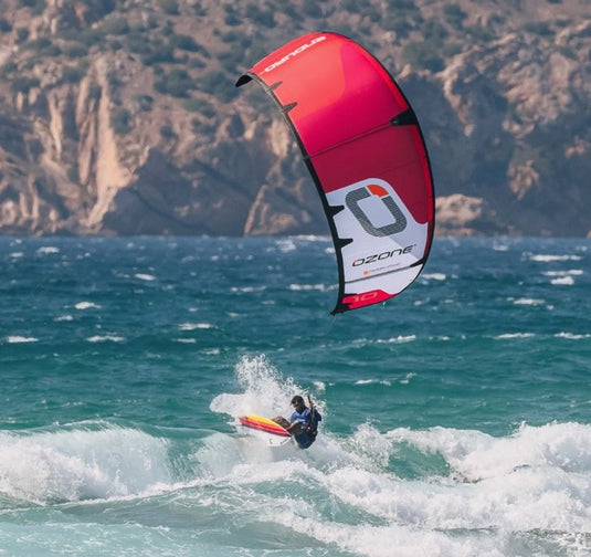 Green Hat Kiteboarding-Ozone Enduro V5 Kiteboarding Kite-10m RED-Action Shot-Kiter surfing a wave on Ozone Enduro Kite