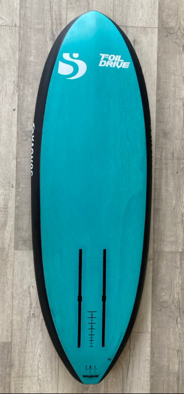 Green Hat Kiteboarding-Sunova X 4'8 Foil Drive Foilboard USED-Bottom View on a Wooden Background