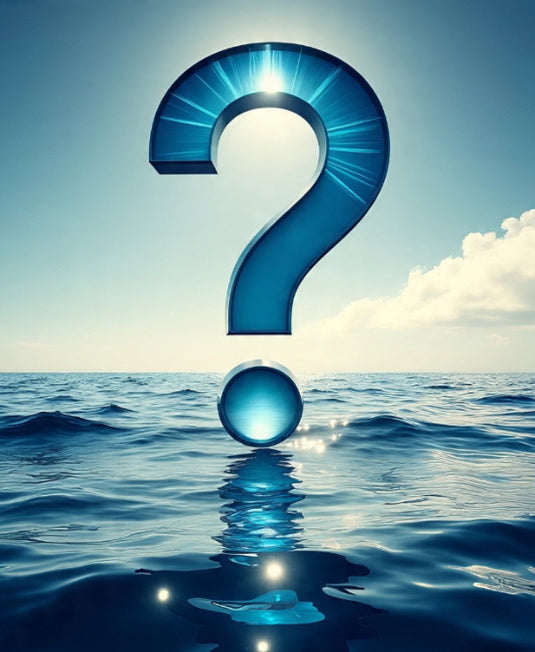 Green Hat Kiteboarding-Large blue question mark emerging from water with a clear sky background