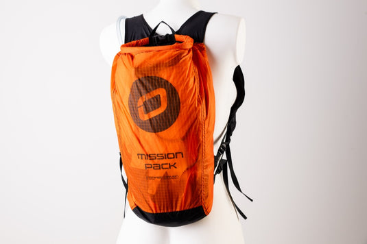 Orange backpack with 'Mission Pack' branding on a white background