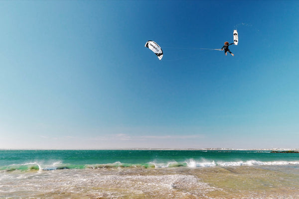 A person kiteboarding with the Core XR7 Kite, soaring above the ocean.